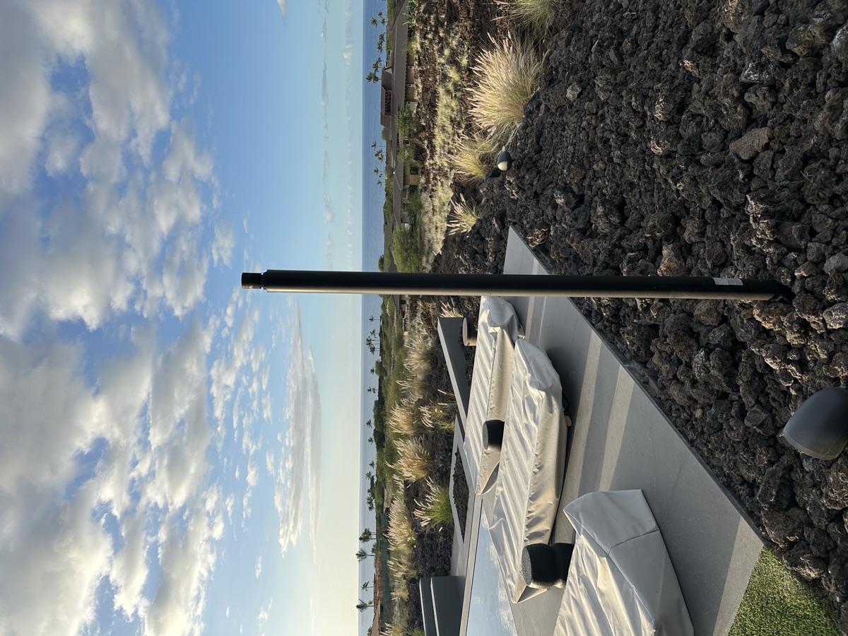 Automated gas tiki torch standing in tropical landscape — Kailua Kona, Hawaii